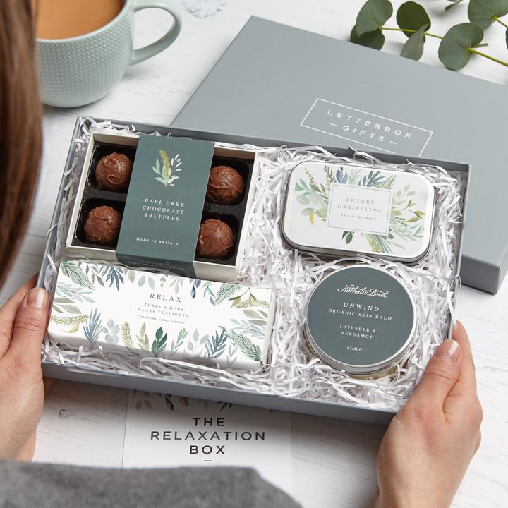 A relaxation gift set with tea, truffles, candles and a body balm