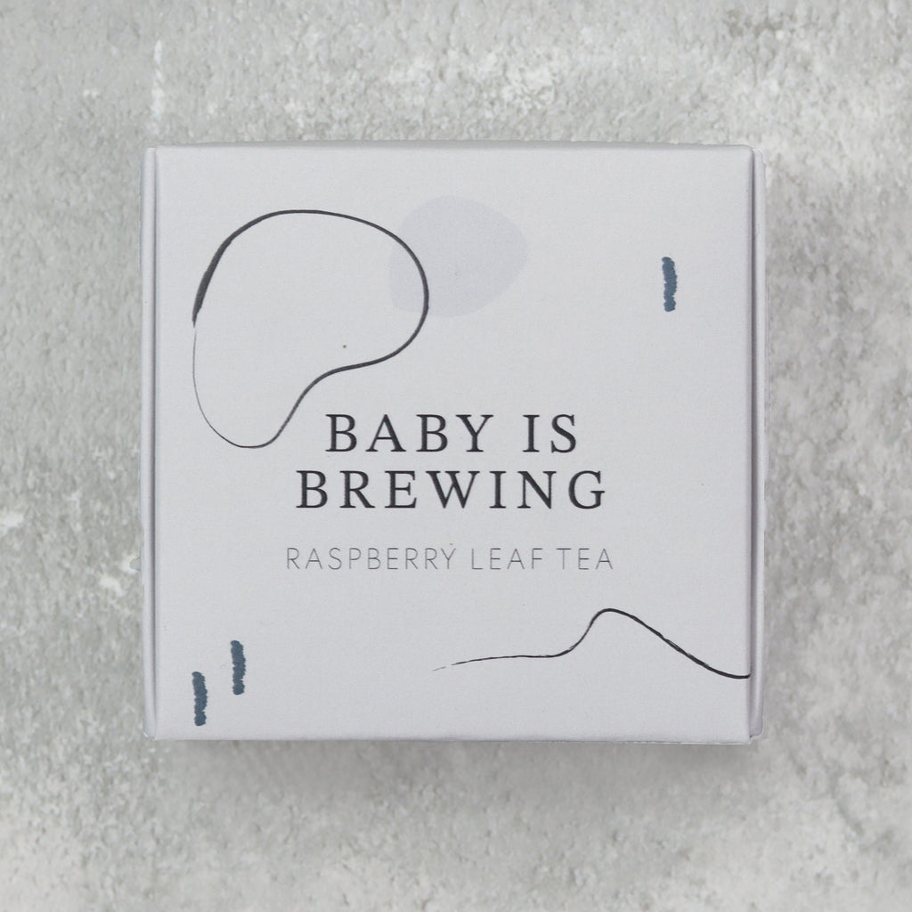 Baby is brewing raspberry leaf tea in a recyclable cardboard gift box