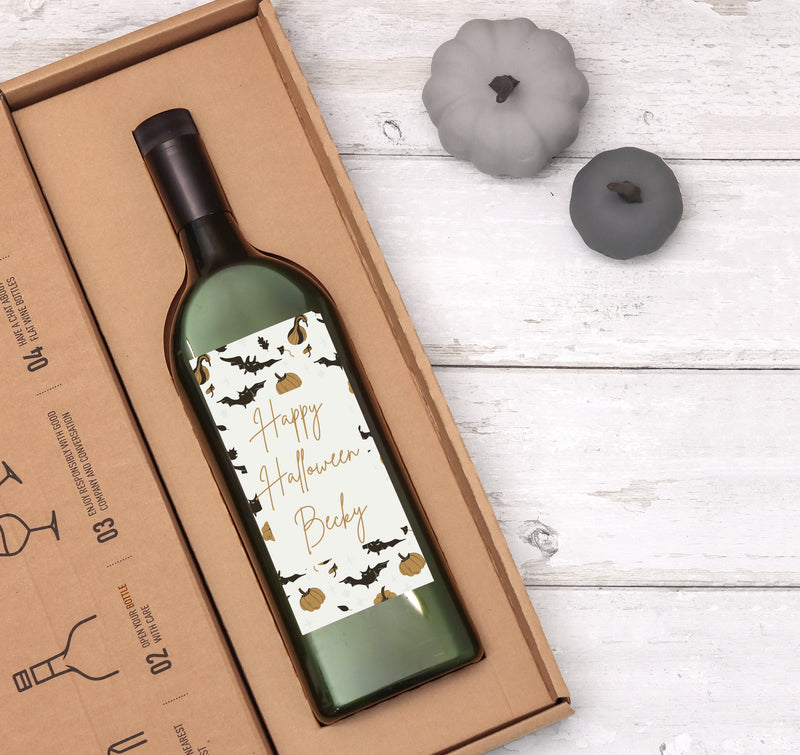 Letterbox wine bottle with personalised name on a happy halloween label with bat and pumpkin images in a letterbox-friendly cardboard box