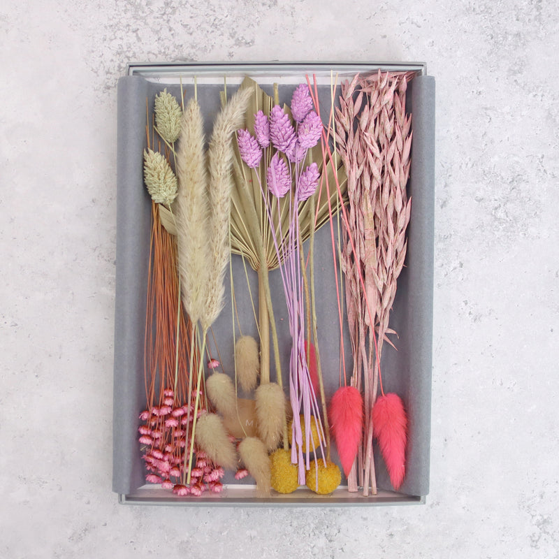 Pink, purple, yellow and natural dried flowers arranged in a letterbox-friendly gift set