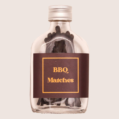Black BBQ matches in glass bottle