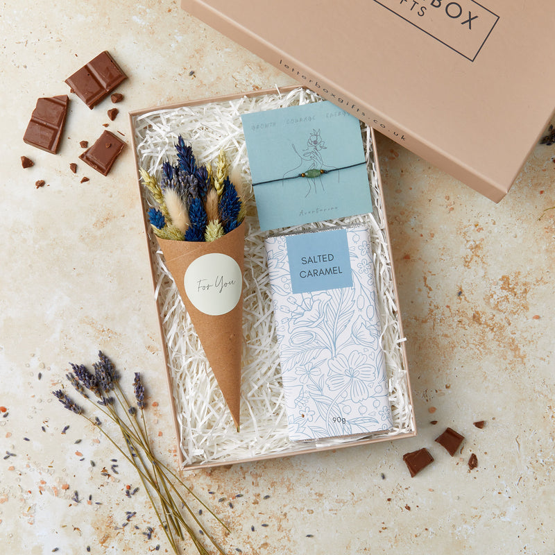 Letterbox-friendly gift set containing aventurine gemstone bracelet, salted caramel chocolate bar and blue and white dried flower posy