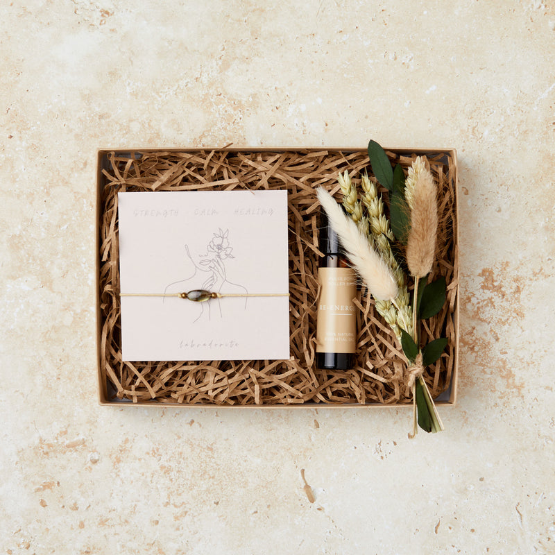 Mini wellbeing gift set containing labradorite gemstone bracelet, aromatherapy oil roll on and mini neutral dried flower posy in a mini brown gift box