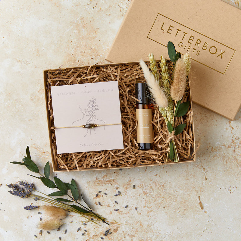 Mini wellbeing gift set containing labradorite gemstone bracelet, aromatherapy oil roll on and mini neutral dried flower posy in a mini brown gift box