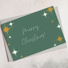 A6 greetings card in forest green with 'merry christmas' and yellow stars