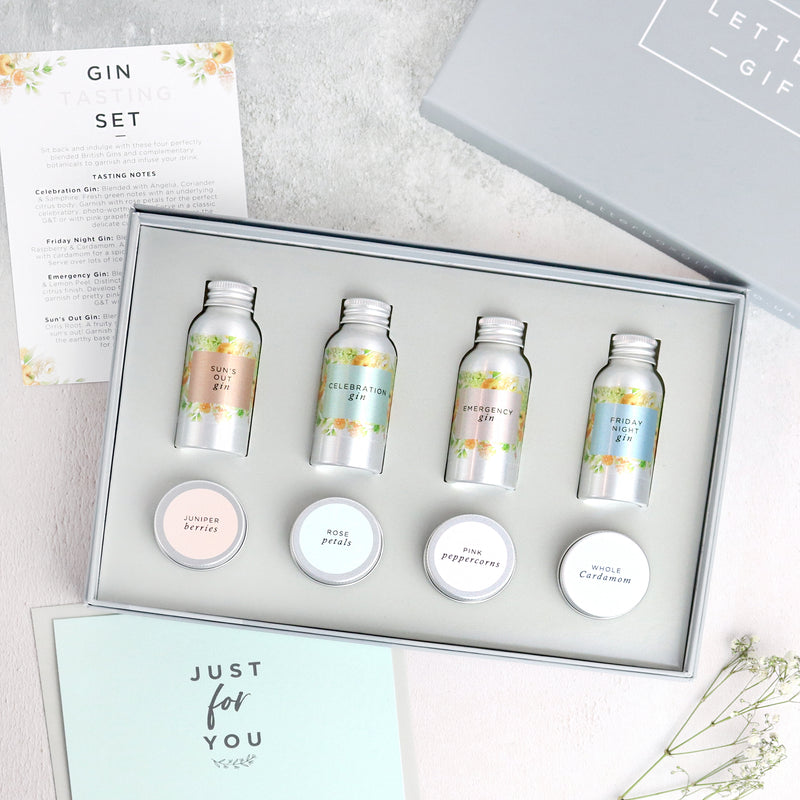 Summer gin tasting set containing 4 gin miniatures and 4 gin botanicals tins in a letterbox-friendly gift set