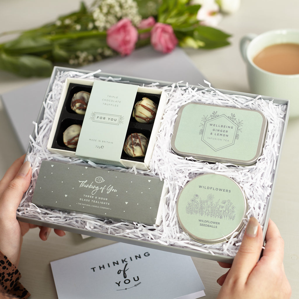Letterbox 'Thinking of you' Gift set containing chocolate truffles, lemon & ginger tea tin, wildflower seed balls & thinking of you tealights with greetings card