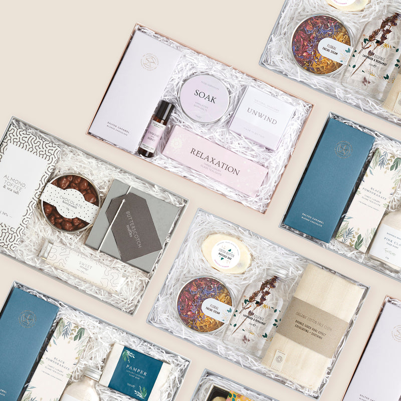 a selection of gift sets containing chocolates, candles and spa gifts
