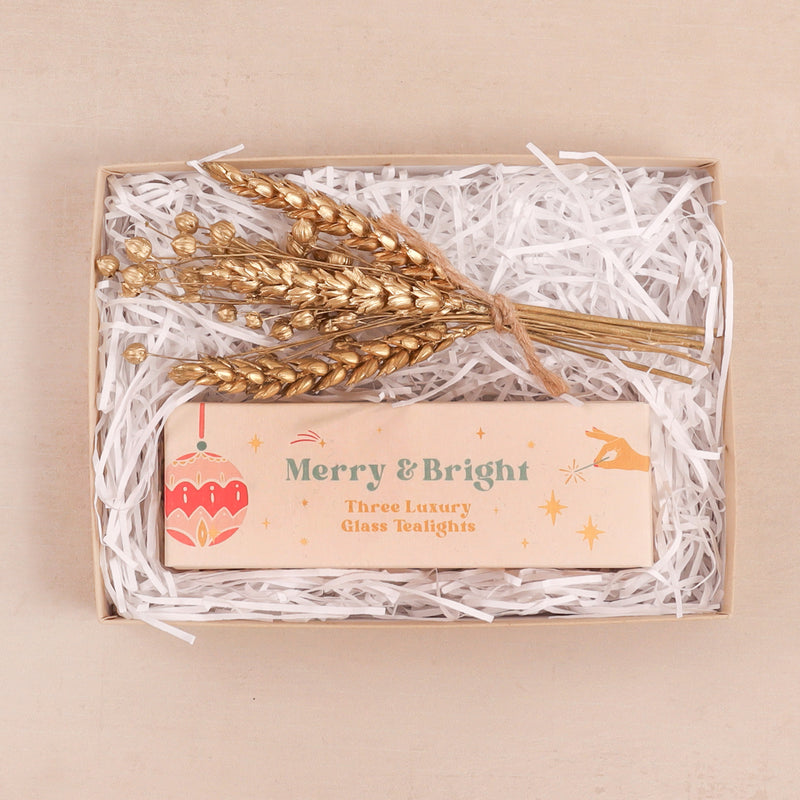 Christmas mini letterbox gift set containing gold flowers and 'merry & bright' tealights with personalised name on the inner lid