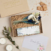 Mini thank you gift set containing thank you tealights and blue & white dried flower posy in a kraft box