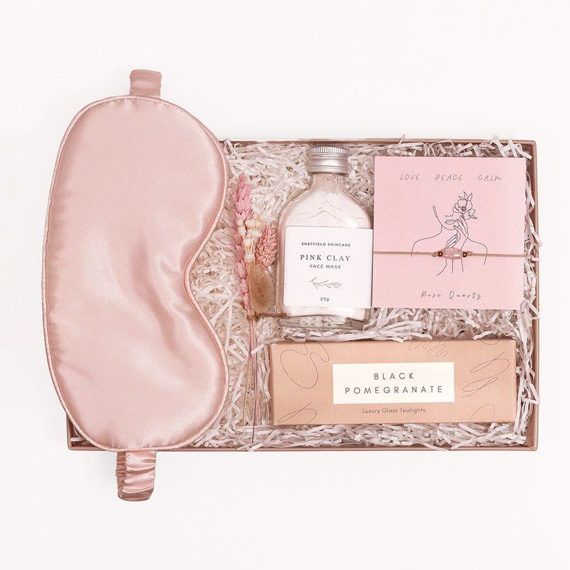 Month 1 - Valentine's Day gift set containing silk eye mask. rose quartz bracelet, black pomegranate tealights, pink clay face mask & mini flower posy