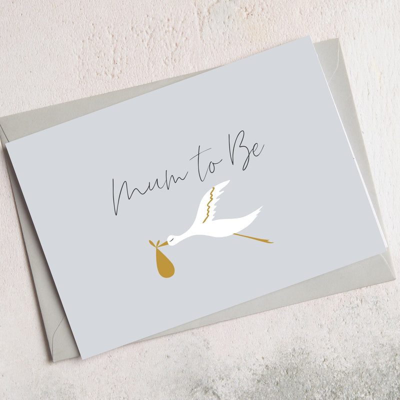 A6 greetings card with 'Mum to Be' text and white crane holding a gold baby bundle