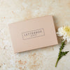 Tan brown gift box with 'letterbox gifts' text on the lid