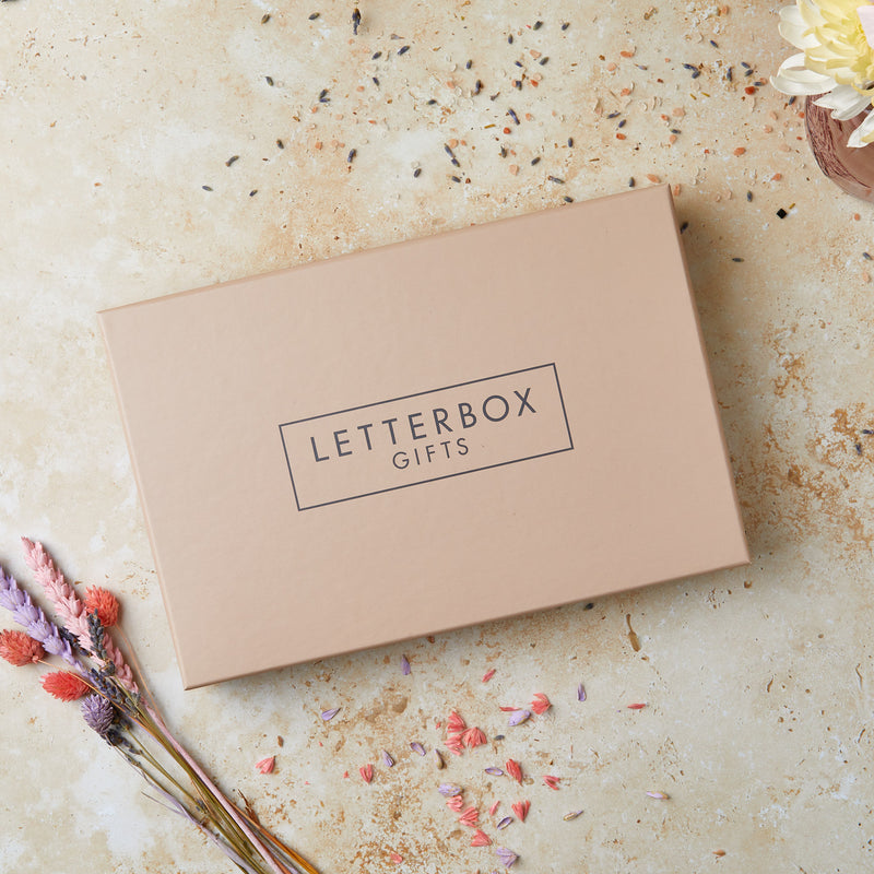 A tan brown gift box with 'letterbox gifts' text on the lid