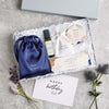 Perfect night's sleep gift set containing dark blue silk eye mask, sleep better pulse point roll on, lavender pouch, calm balm & tealights