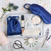 Perfect night's sleep gift set containing dark blue silk eye mask, sleep better pulse point roll on, lavender pouch, calm balm & tealights