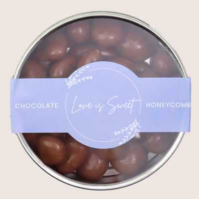 Chocolate honeycomb bites in a tin with blue 'love is sweet' sticker