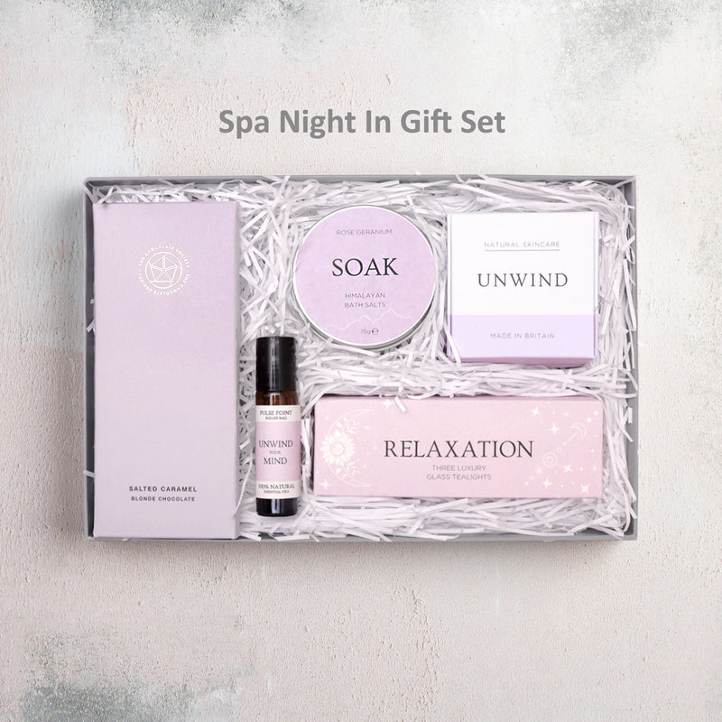 Spa Night In gift set containing chocolate bar, aromatherapy roll on oil, bath bomb, Himalayan pink bath salts and relaxation tealights in purple design