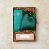 Letterbox-friendly gift set containing green silk eye mask, cocktail chocolate bar and black pomegranate tealights