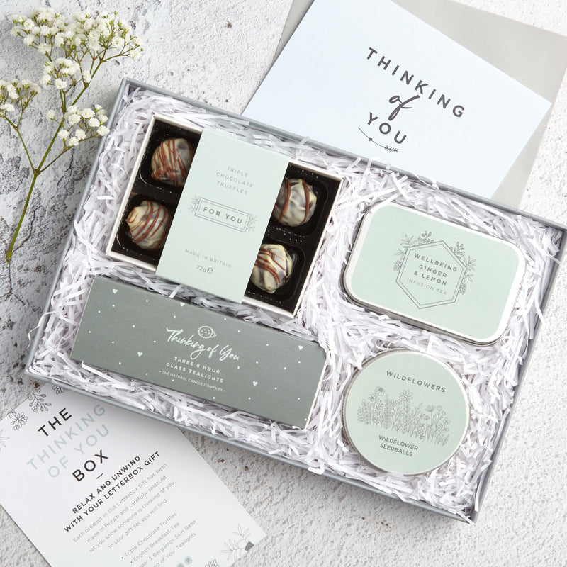 Letterbox 'Thinking of you' Gift set containing chocolate truffles, lemon & ginger tea tin, wildflower seed balls & thinking of you tealights with greetings card