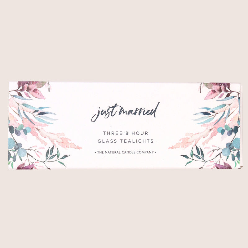 Three glass tealights in a pink and blue leafy sleeve with 'just married' text