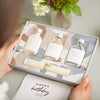 Facial spa gift set containing three clay face masks in glass bottles and muslin face cloth