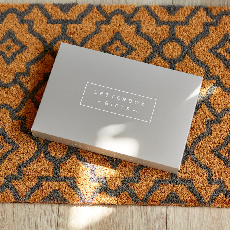 Letterbox gift box on an orange and black doormat