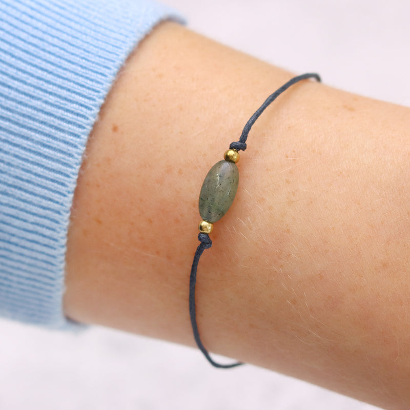 An aventurine gemstone bracelet being displayed on a person's wrist