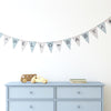 a grey and green garland of bunting with the words hello baby in a baby's bedroom