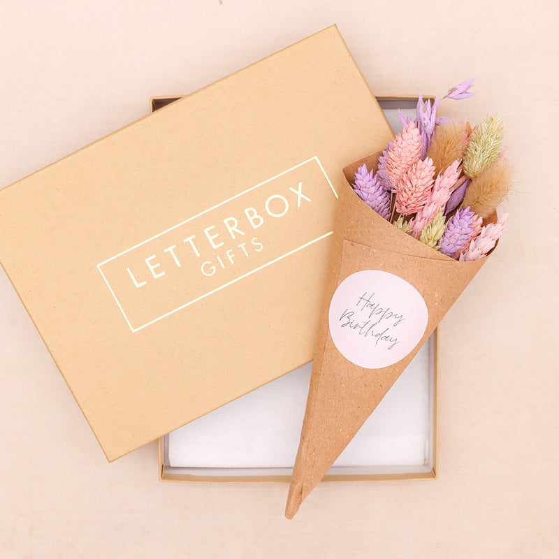 Pink and purple pastel dried flower posy in kraft cone with a happy birthday sticker, in a kraft letterbox gifts box