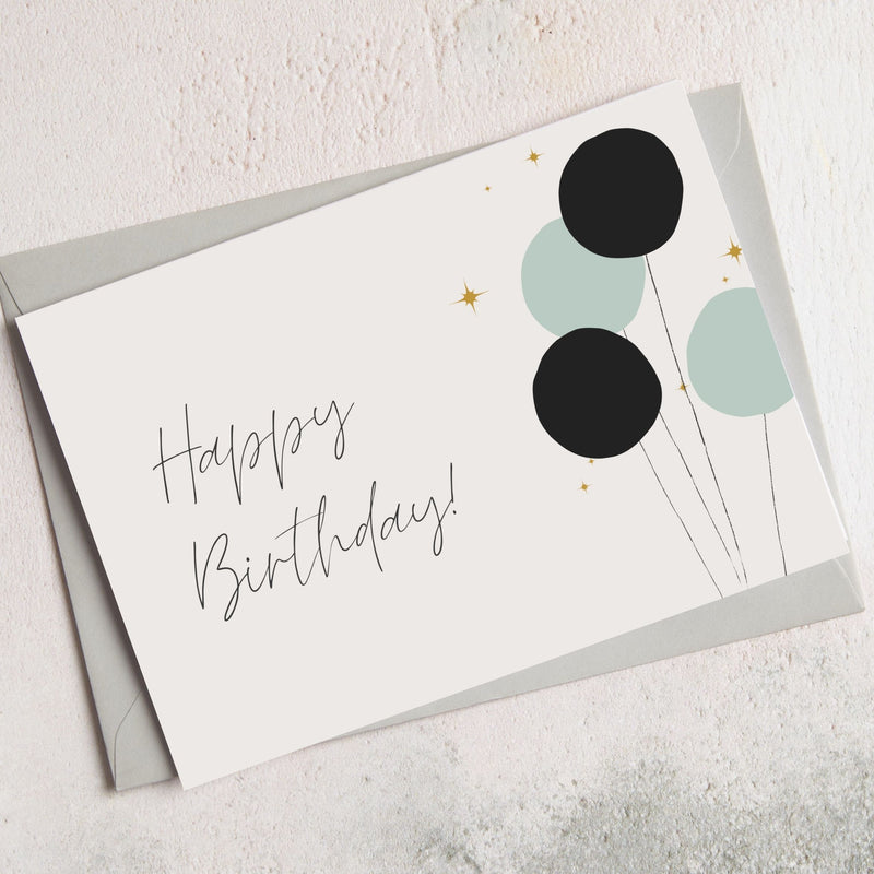 an A6 Happy Birthday card with an art deco balloon design and 'Happy Birthday' written in a handwriting style script font