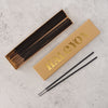 Black pomegranate scented incense sticks in a yellow gold-foiled Halcyon gift box