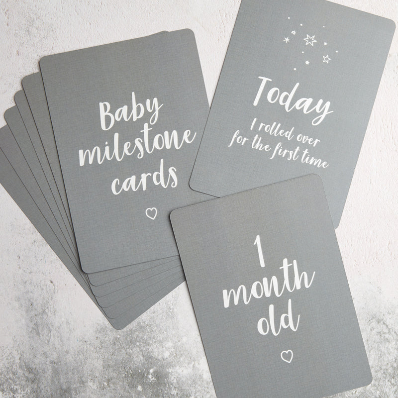 Grey baby milestone card set including 'Today I rolled over for the first time' and '1 month old'