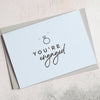 Light Blue 'You're Engaged' Greeting card  in handwriting font with a ring image