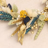 Close up of the gold, blue, yellow & natural dried flower wreath