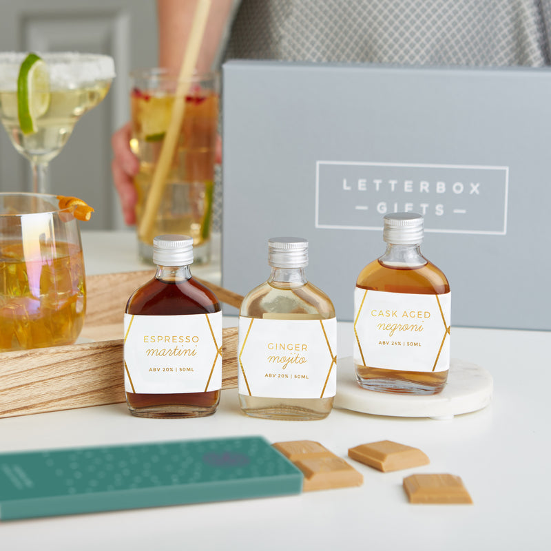 The 'Cocktail' Letterbox Gift set containing three cocktails in glass bottles,  bamboo straw and a gin & tonic chocolate bar