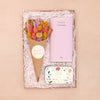 Easter floral letterbox gift set containing salted caramel chocolate bar, white peony loose leaf tea tin and pink, purple and yellow pastel dried flower posy in kraft cone with happy easter sticker