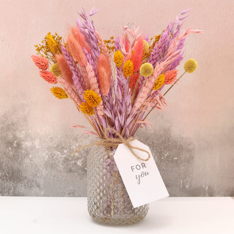 Pink, purple and yellow pastel dried flower bouquet with for you tag, arranged in a glass vase