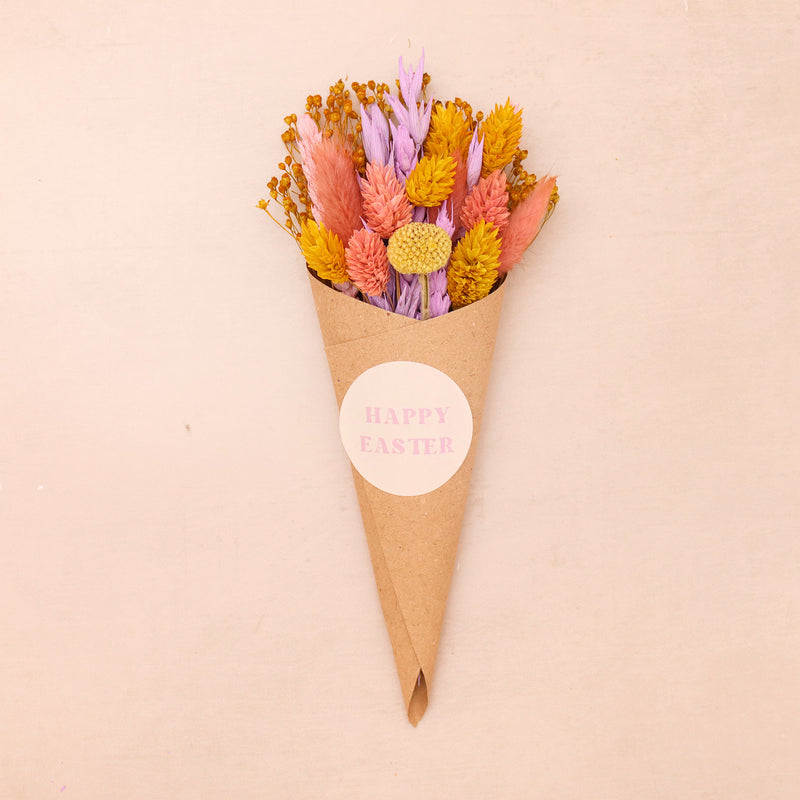 Pink, purple and yellow pastel dried flower posy in kraft cone with happy easter sticker