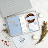 Engagement gift set in blue and white containing wedding planner notebook, chocolate honeycomb, Darjeeling tea for two box and You're Engaged tealights