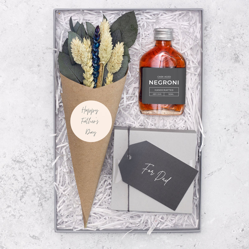 Father's Day letterbox gift set containing cask-aged negroni cocktail, for dad butterscotch truffles and a eucalyptus and neutral-tone dried flower posy