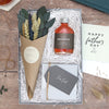 Father's Day letterbox gift set containing cask-aged negroni cocktail, for dad butterscotch truffles and a eucalyptus and neutral-tone dried flower posy