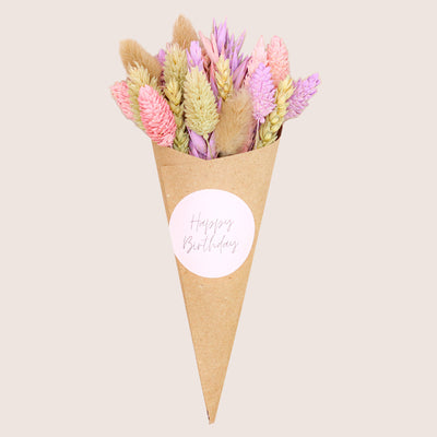 Pink, purple & neutral pastel dried flower posy in kraft cone with happy birthday sticker