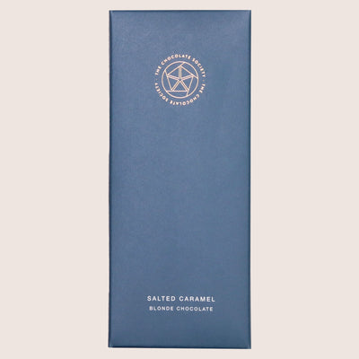 Salted caramel blonde chocolate bar in dark blue cardboard box