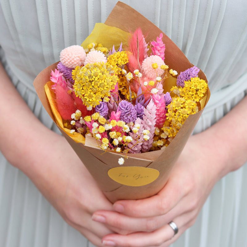 Bright summer dried flowers in pink, purple and yellow in  a pre-arranged bouquet with Kraft cone and For You sticker