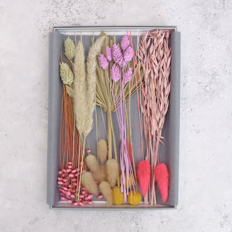 Pink, purple, yellow and natural dried flowers arranged in a letterbox-friendly gift set