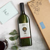 Letterbox-friendly red wine bottle next to cardboard packaging and just for you greetings card