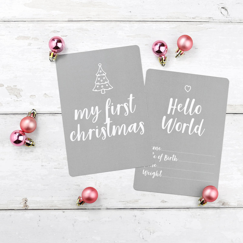 Grey baby milestone cards with red christmas baubles reading 'My first Christmas'; and 'Hello World'
