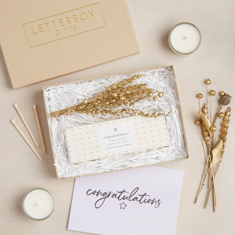 Mini congratulations letterbox gift set containing pastel yellow congratulations tealights & gold dried flower posy