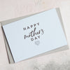 a light blue Happy Mother's Day card with a heart icon placed on a grey envelope